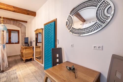 a room with a table and a mirror on the wall at Couvent des Carmes in Narbonne