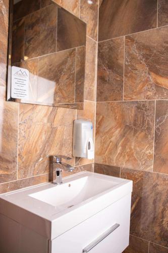 a bathroom with a sink and a mirror at Penzión Furkotka in Štrbské Pleso