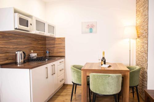 a kitchen with a table and chairs and a microwave at Penzión Furkotka in Štrbské Pleso