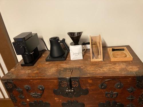 a wooden chest with various items on top of it at HacheonBaramJip Angeori Stay Curated by Actor Ryu Seungryong in Jeju