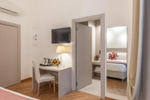 a room with a desk and a bed and a mirror at Palazzo Indelli in Monopoli