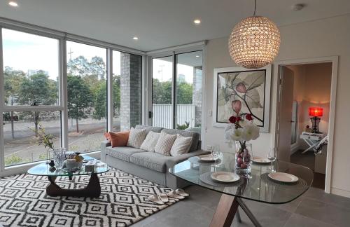 a living room with a couch and a table at The Atrium - Olympic Park 50m to ACCOR FREE PARK in Sydney