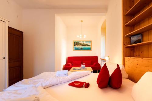 a bedroom with a bed and a red couch at Villa Marienhof in Annenheim