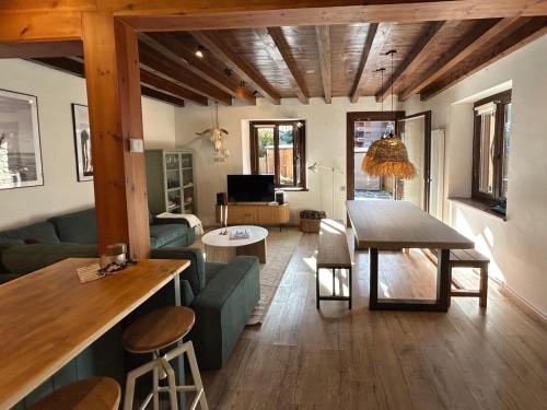 a living room with a couch and a table in it at Chalet con encanto Jardín y Parking Privado in Vielha