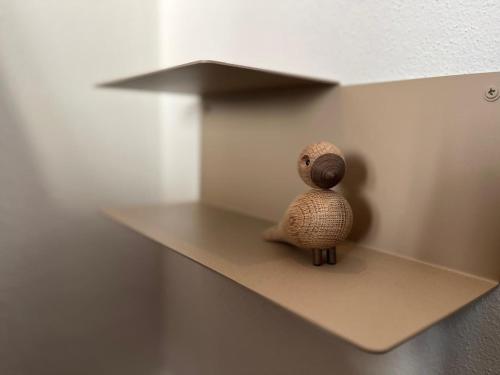 a stuffed animal is sitting on a shelf at Die Weinrose - Natura Lago Monti in Montemezzo