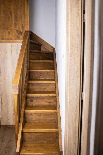 a wooden staircase in a room with a wooden wall at Penzión Furkotka in Štrbské Pleso