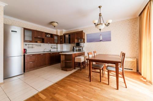 a kitchen and dining room with a table and chairs at ApartComplex Splendid in Saints Constantine and Helena