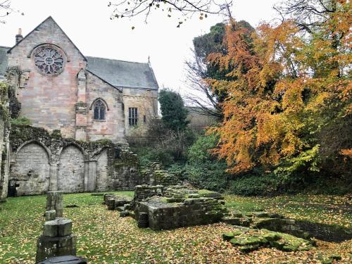 an old stone church with a clock on it at A 2 Bedroom flat in Culross home of Outlander in Culross