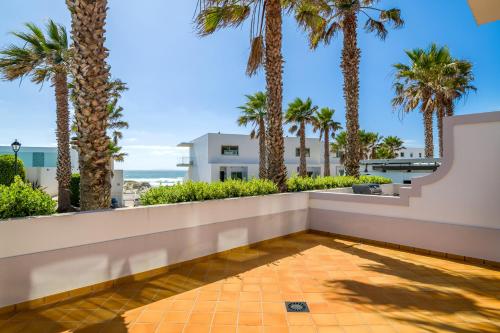 a view from the balcony of a house with palm trees at Praia D'el Rey A1 - Golf & Beach in Óbidos
