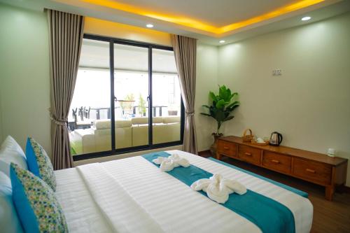 a bedroom with a large bed with towels on it at HaiVen Angkor Residence & Hotel in Siem Reap