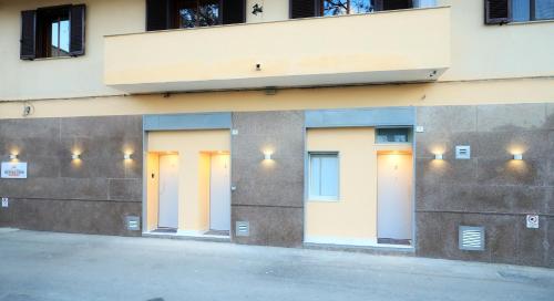 a row of doors on the side of a building at B&B REVOLUTION BED e BREAKFAST in Caserta
