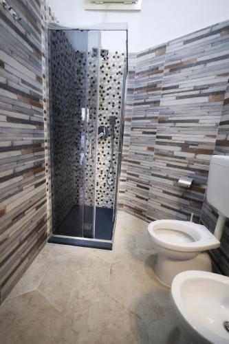 a bathroom with a shower with a toilet and a sink at B&B REVOLUTION BED e BREAKFAST in Caserta