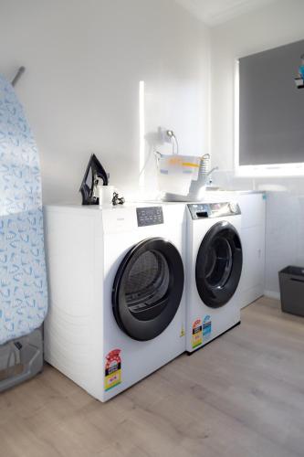 a washer and dryer sitting in a room at House in Palmerston North, New Zealand in Palmerston North