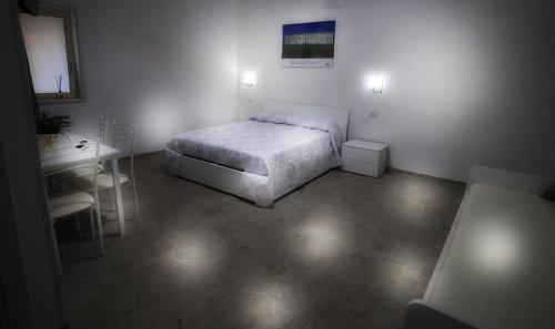 a small bedroom with a bed and a desk at B&B REVOLUTION BED e BREAKFAST in Caserta