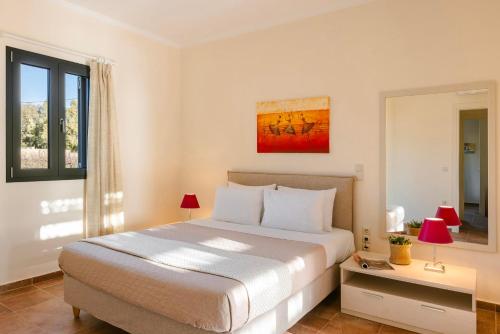 a bedroom with a large bed and a window at Saluto by Vintage Travel in Spartia