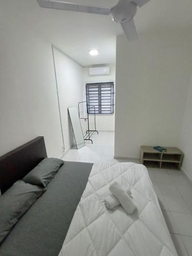 a bedroom with a bed with two pillows on it at Seroja Guesthouse Gambang in Gambang