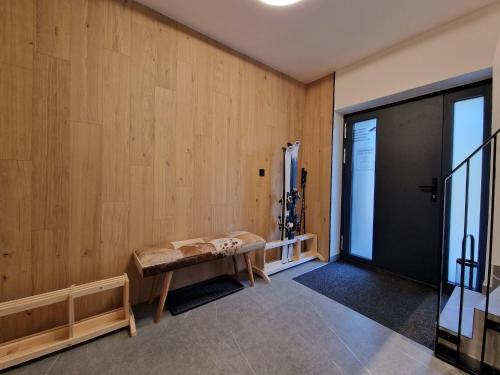 a room with a wooden wall with a bench at Apartment in Krkono e near Ski Slopes in Pec pod Snezkou