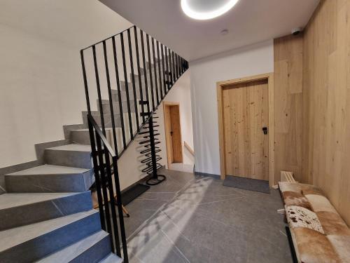 a spiral staircase in a house with a wooden door at Apartment in Krkono e near Ski Slopes in Pec pod Snezkou
