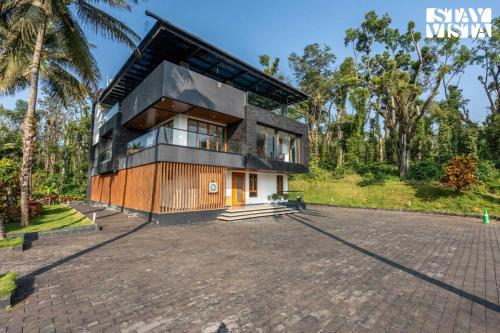 a house with a large driveway at The Rivernook - The perfect place for getaways in Jambur