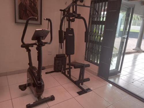 a gym with two exercise bikes in a room at Cheryl's Fortress in Johannesburg