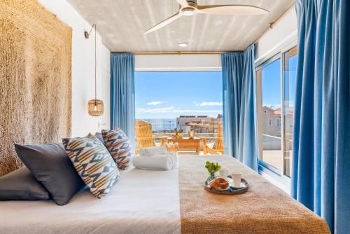 a living room with a couch and a large window at Ixchel Beach House By Sunkeyrents in El Médano