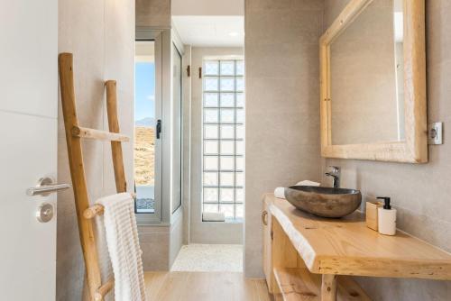 a bathroom with a wooden counter with a sink at Ixchel Beach House By Sunkeyrents in El Médano