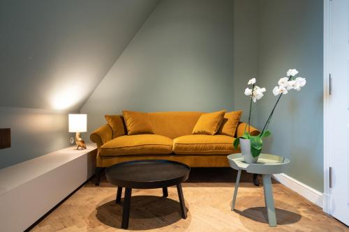 a living room with a couch and a table at Das Tegernsee in Tegernsee