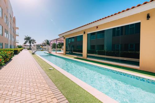 a swimming pool in front of a building at Arubas Life 200 in Noord