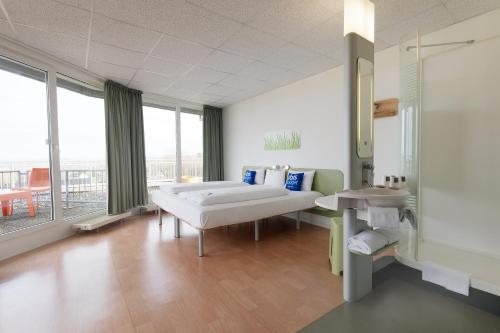 a hospital room with two beds and a balcony at ibis budget Hotel BONN SÜD Königswinter in Königswinter