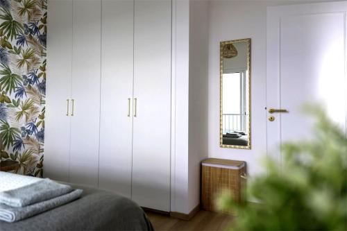 a bedroom with a bed and a mirror in it at Green Oasis Penthouse in Peyia