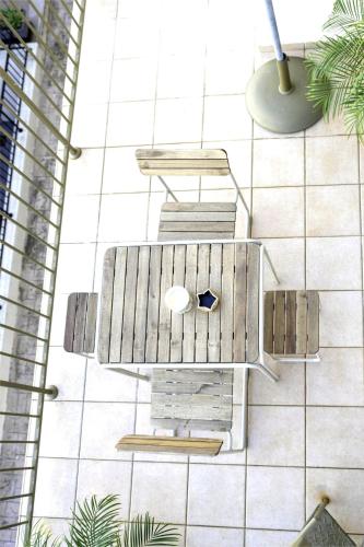 a drawing of a table and benches on a tiled floor at Green Oasis Penthouse in Peyia