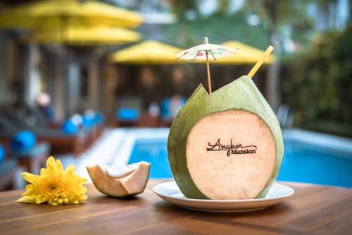 a slice of an avocado with an umbrella on a table at Angkor Mansion & Residence in Siem Reap