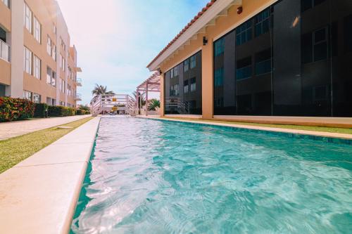 a swimming pool in front of a building at Arubas Life 212 in Noord