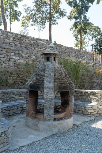 an outdoor brick oven in a stone wall at Nana Mountain Resort in Astam