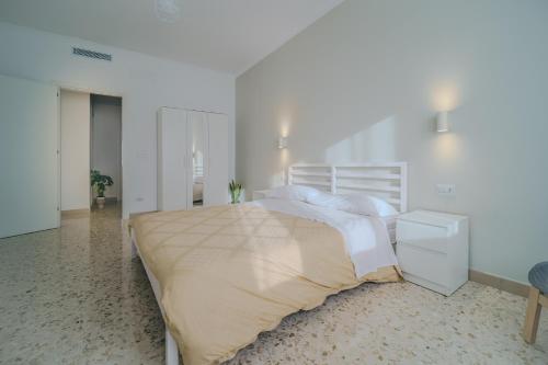 a bedroom with a large bed in a white room at Domus-Pulchra in Bari