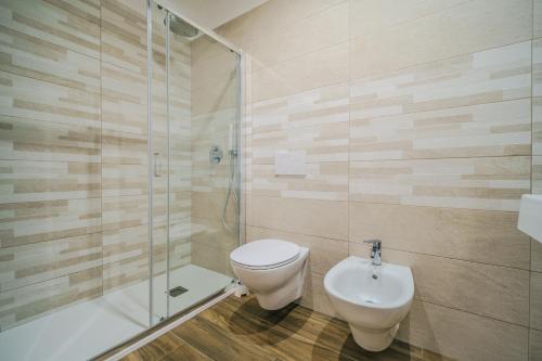 a bathroom with a toilet and a shower and a sink at Domus-Pulchra in Bari