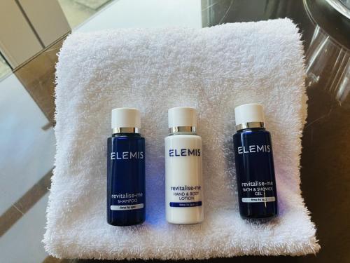 three bottles of elms sitting on a white towel at Macdonald Houstoun House in Livingston