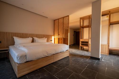a bedroom with a large bed in a room at Nana Mountain Resort in Astam