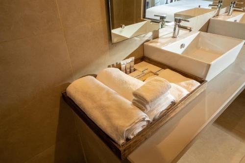 a bathroom with a sink and towels on a counter at Nana Mountain Resort in Astam
