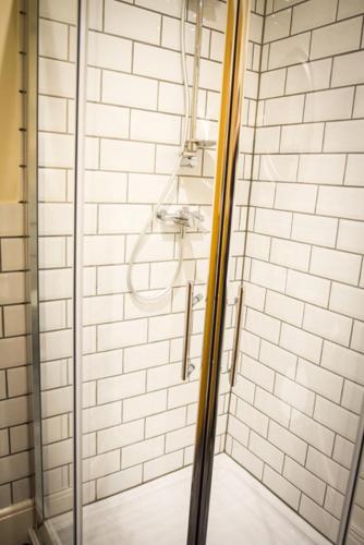 a shower with a glass door in a bathroom at Fair Oak House Exeter Airport in Exeter