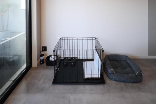 a black bird cage with a couch next to a window at PrivateVilla8 in Minamiawaji