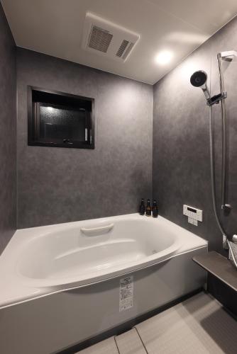 a large white bath tub in a bathroom at PrivateVilla8 in Minamiawaji