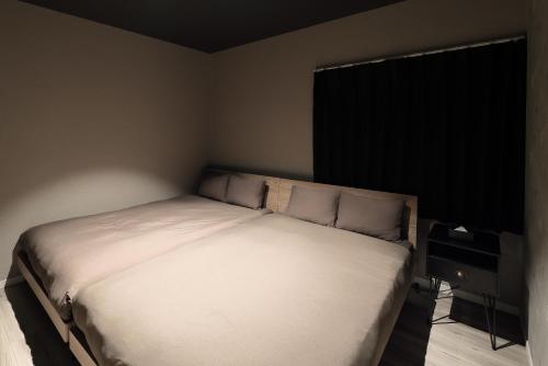 a bedroom with a white bed in a room at PrivateVilla8 in Minamiawaji