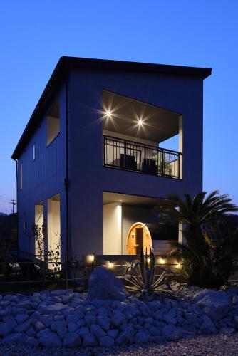 a large house with lights on it at night at PrivateVilla8 in Minamiawaji