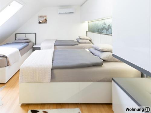 a bedroom with four beds in a room at Exklusives Reihenhaus in Eschenz