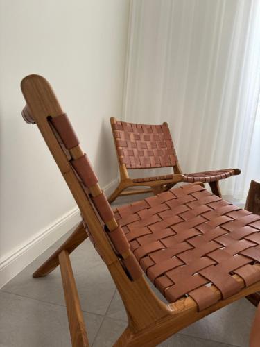 two wooden chairs sitting next to each other at Maison LYO logement Luxe in Cannes