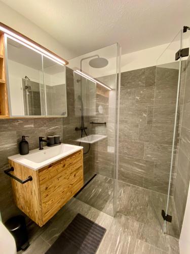 a bathroom with a sink and a shower at house & living junbi in Laax