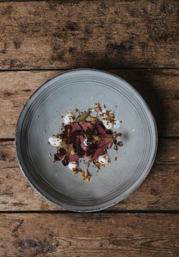 a plate of food on a wooden table at Knutes pensionat in Svansele