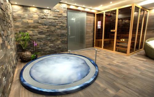 a large blue bath tub in a room at Hotel Pieris in Vysoke Tatry - Podbanske