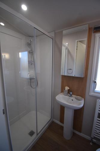 a bathroom with a glass shower and a sink at 25 Poplars Way Walton on Naze in Walton-on-the-Naze